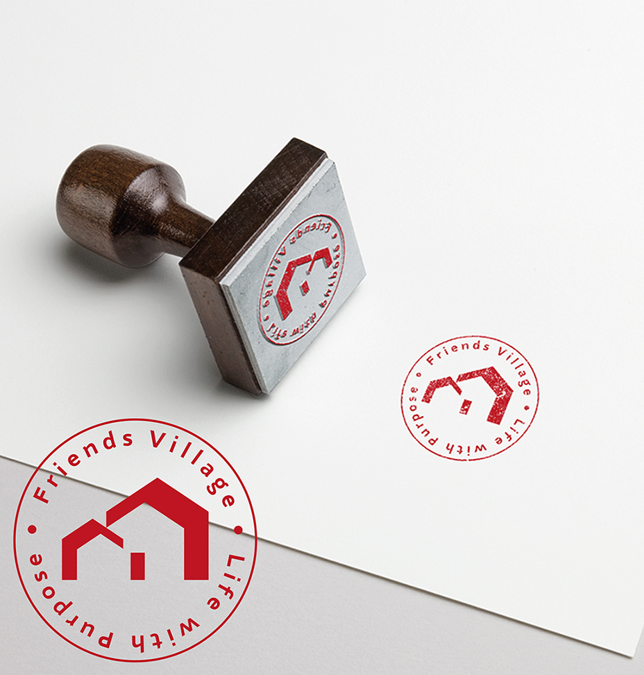 stamp lying down on pager with red circular stamps that say Friends Village and the logo